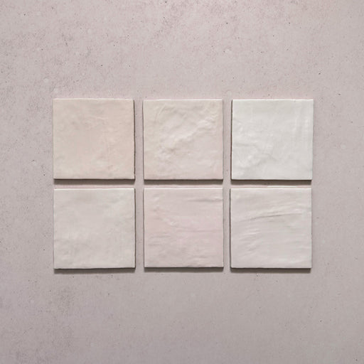 Zellij Pink Mist square Moroccan-style tiles, 13.2cm x 13.2cm, soft blush pink colour with subtle tonal variation, glossy glazed finish, gently uneven handmade surface, arranged as a tile sample group.