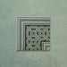 Single Europa Toulouse Corner 20x20cm Victorian Moroccan style tile displayed against a textured green background, featuring a decorative corner border design in green, grey and cream tones.