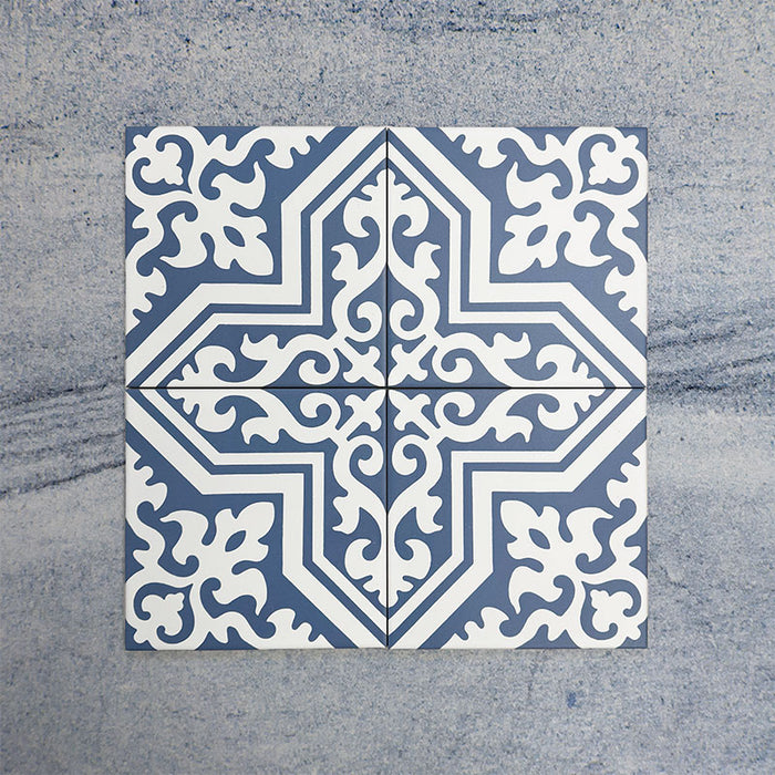 Four Europa Trondheim Blue 20x20cm Victorian Moroccan style tiles arranged together to showcase the repeating decorative pattern in blue and white tones, displayed against a textured grey background.