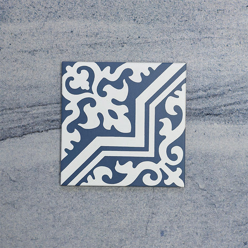 Single Europa Trondheim Blue 20x20cm Victorian Moroccan style tile displayed against a textured grey background, featuring a decorative geometric and floral pattern in blue and white tones in a close-up product setting.
