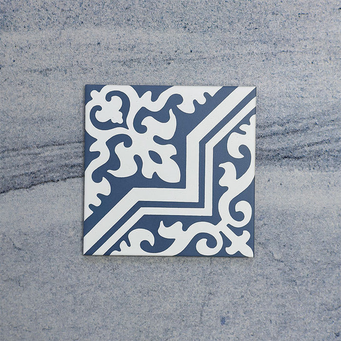 Single Europa Trondheim Blue 20x20cm Victorian Moroccan style tile displayed against a textured grey background, featuring a decorative geometric and floral pattern in blue and white tones in a close-up product setting.
