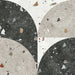 Tulsa Decor Terrazzo 66 × 66cm porcelain wall and floor tile, featuring a terrazzo base with multicoloured aggregate chips combined with bold geometric quarter-circle patterning in contrasting light and dark tones, creating a striking, contemporary statement design.