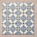Grouped layout of Carnaby Turner Victorian-style 20x20cm porcelain wall and floor tiles, showing the full repeating blue, cream, and charcoal geometric cross pattern with small gold accents on an aged background.
