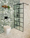Contemporary bathroom featuring Venetian Emerald Matt 60cm x 60cm terrazzo effect porcelain wall tiles, paired with Venetian Ivory floor tiles, a black-framed shower screen, black brassware and warm wooden accents.