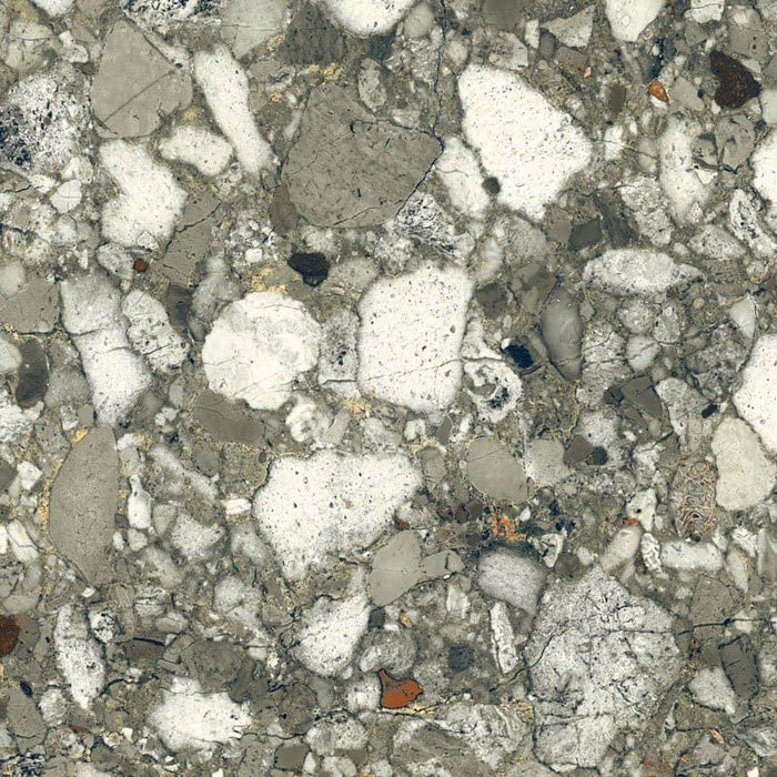 Close-up of Venetian Emerald Matt 60cm x 60cm terrazzo effect porcelain tile, featuring rich green, grey and white stone-inspired aggregates with a matt finish for contemporary wall and floor designs.