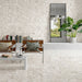 Modern living room featuring Venetian Ivory 60cm x 60cm terrazzo effect polished porcelain wall and floor tiles, creating a bright, seamless interior with contemporary furniture, indoor plants and elegant stone-inspired detailing.