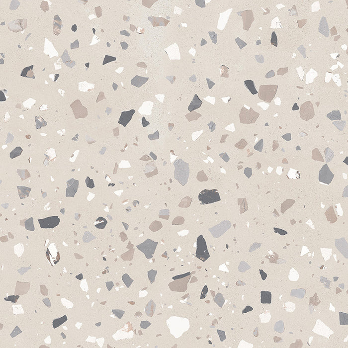 Close-up of Veneto Medium Sand concrete effect porcelain tile featuring a warm sand-coloured background with medium terrazzo stone chips in soft grey, beige and white tones, creating a contemporary surface for walls and floors.