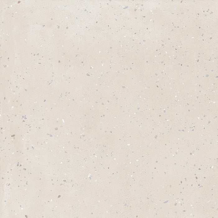 Close-up of Veneto Micro Sand concrete effect porcelain tile featuring a warm sand-coloured background with fine terrazzo flecks, creating a subtle, contemporary surface ideal for modern walls and floors.