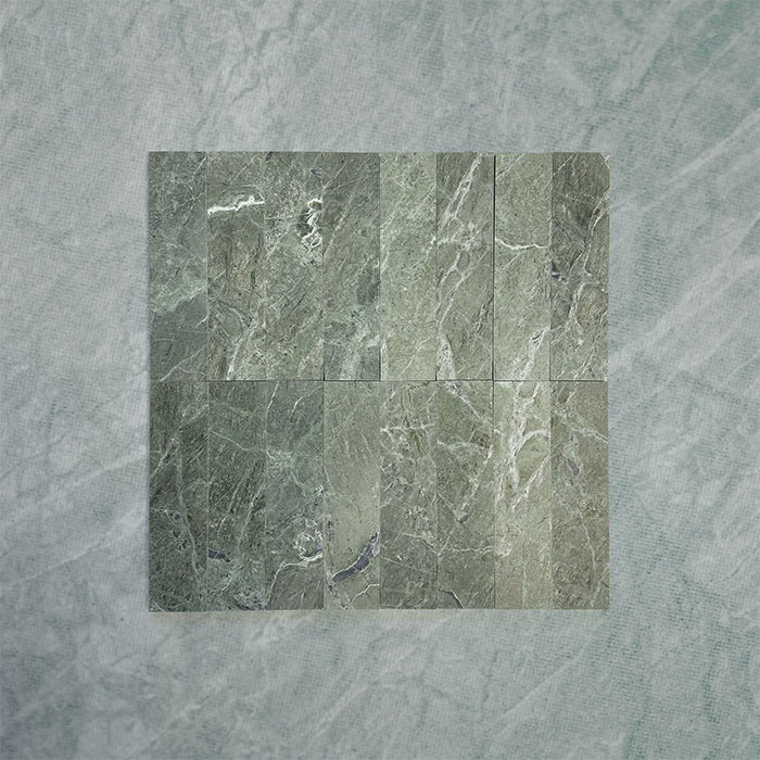 Grouped Fitzrovia Verde 5 x 20cm honed natural marble tiles arranged together to showcase the full variation of the range, featuring rich green tones with soft tonal shifts and natural veining, highlighting the depth and character across multiple pieces.