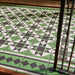 Maison Green Decor Victorian Pattern 20cm x 20cm walkway setting, Victorian-style patterned floor tiles laid in a geometric diamond design, rich green, black and white colour palette, matt finish with decorative border detailing, classic heritage-inspired design used in an outdoor entrance walkway.