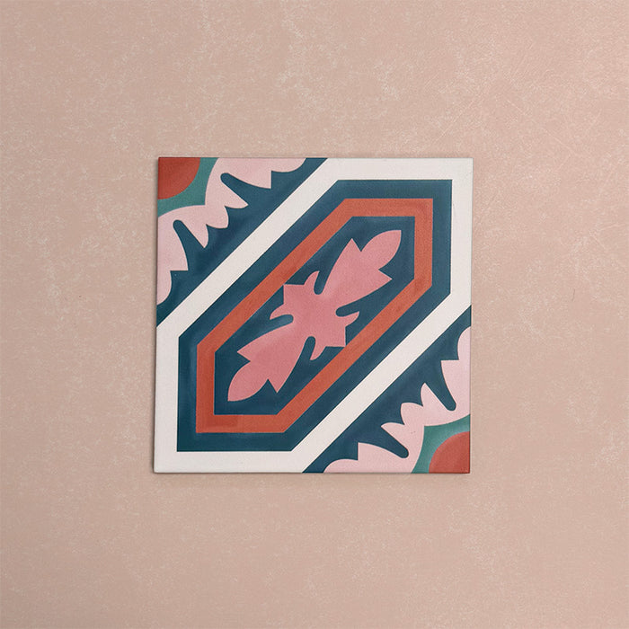 Single Europa Vienna 20x20cm Victorian Moroccan style tile displayed against a textured pink background, featuring a decorative geometric and floral pattern in blue, pink and coral tones in a close-up product setting.