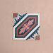 Single Europa Vienna 20x20cm Victorian Moroccan style tile displayed against a textured pink background, featuring a decorative geometric and floral pattern in blue, pink and coral tones in a close-up product setting.