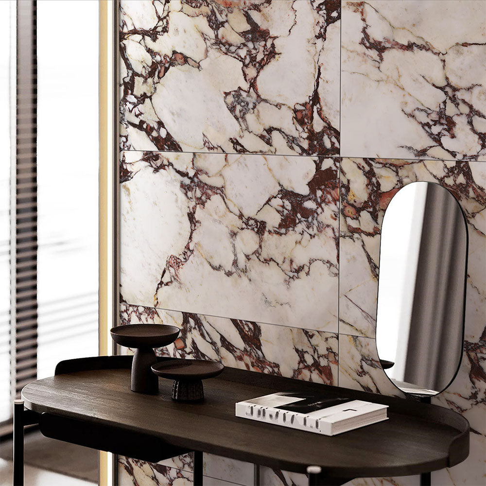 Interior setting featuring Grand Violetta Matt Honed Marble effect 60 × 60cm porcelain wall tiles, styled with a dark wood console, sculptural decor, and soft lighting highlighting bold veining and a refined matt finish.