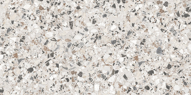 Close-up of the Vito Moonstone 60x120cm terrazzo style porcelain tile, featuring a soft light grey base with a blend of white, silver, charcoal and taupe stone fragments. The realistic 4D brushed finish enhances the texture and depth, creating an authentic terrazzo effect.