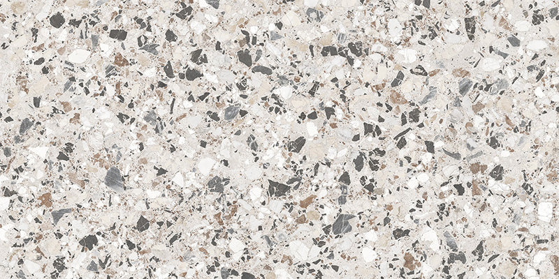 Close-up of the Vito Moonstone 60x120cm terrazzo style porcelain tile, featuring a soft light grey base with a blend of white, silver, charcoal and taupe stone fragments. The realistic 4D brushed finish enhances the texture and depth, creating an authentic terrazzo effect.