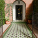 Maison Green Decor Victorian Pattern 20cm x 20cm walkway setting, Victorian-style patterned floor tiles laid in a geometric diamond design, rich green, black and white colour palette, matt finish with decorative border detailing, classic heritage-inspired design used in an outdoor entrance walkway.