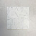 Group of Fitzrovia White 5x20cm honed natural marble brick tiles arranged in a neat layout, showcasing soft white tones, subtle grey veining, and a smooth, refined finish ideal for wall installations.