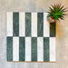 Fitzrovia Verde 5 x 20cm honed natural marble tiles arranged in a vertical striped layout, combining deep green marble with soft white tones to create a clean, balanced contrast, highlighting the natural variation and linear design potential of the collection.
