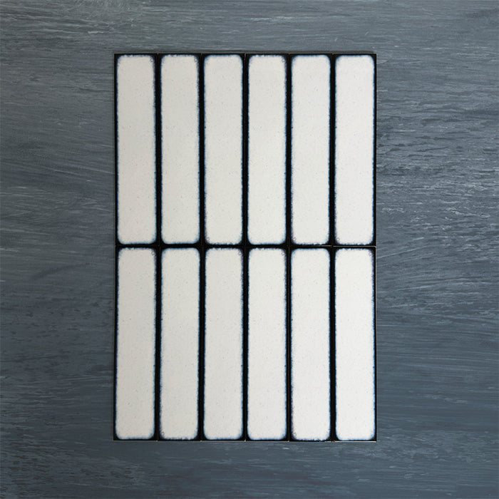 Group of Chemistry White 6.5cm x 30cm rectangular ceramic wall tiles, showcasing a glossy crackle-effect white glaze with subtle tonal variation and an artisan handcrafted effect finish.