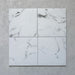 Four Calacatta Blanca White marble-effect 25×25cm porcelain tiles displaying natural grey veining variation, ideal for creating an authentic marble look across floors and walls in contemporary and classic interiors.