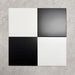 Four Chessboard White and Black 25×25cm Victorian-style porcelain tiles arranged in a classic chequerboard layout to showcase colour contrast, smooth satin finish, and pattern potential, displayed against a light textured background.