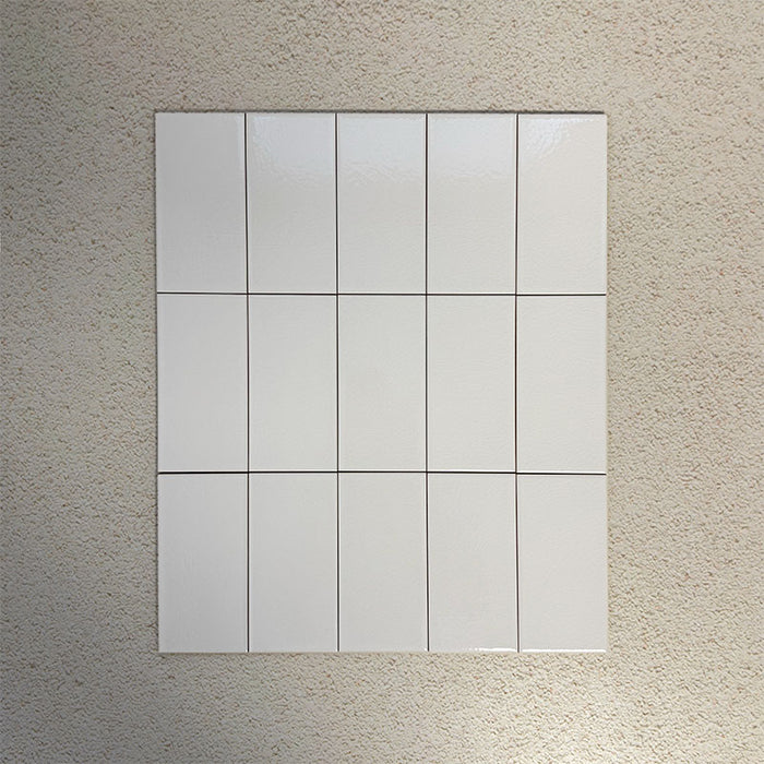 Flat lay of Finchley White 7.5 × 15cm ceramic tiles with a crackle glaze finish, showcasing subtle surface texture and tonal variation, ideal for classic and contemporary wall tile designs.