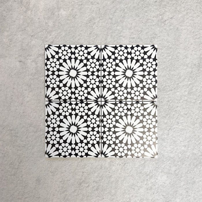 Fizaan Winter Mini Moroccan-style 15×15cm porcelain tiles laid in a repeating geometric pattern, featuring a black and white star motif.