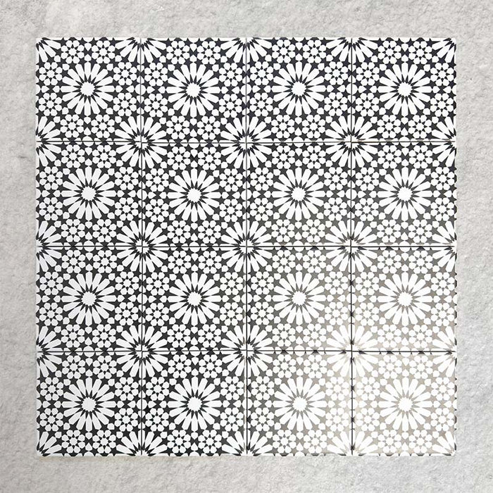 Fizaan Winter Mini Moroccan-style 15×15cm porcelain tiles laid in a repeating geometric pattern, featuring a black and white star motif.