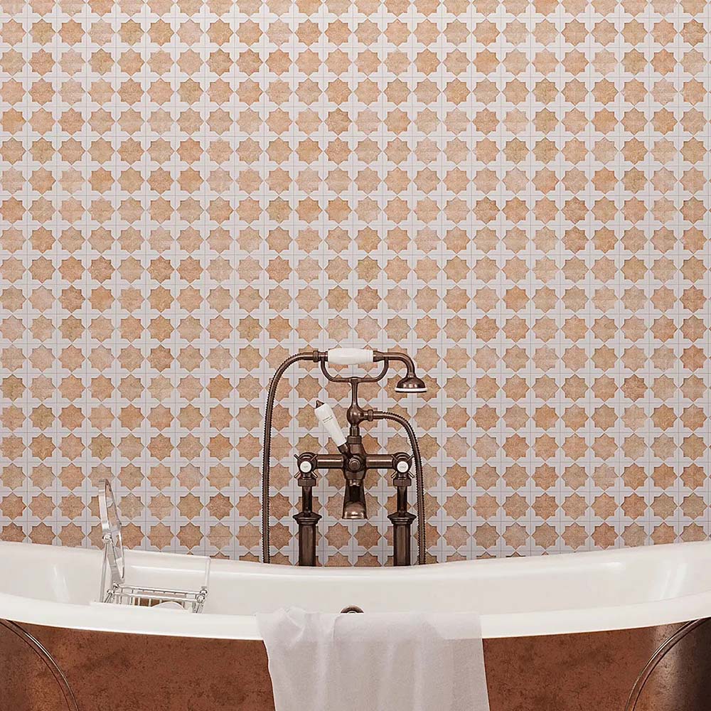 Bathroom featuring Zeina Moroccan Cotto White ceramic wall tiles in a repeating Moroccan style geometric pattern, paired with a freestanding copper bath, terracotta effect floor tiles, arched window, woven pendant light and olive trees for a warm Mediterranean-inspired retreat.