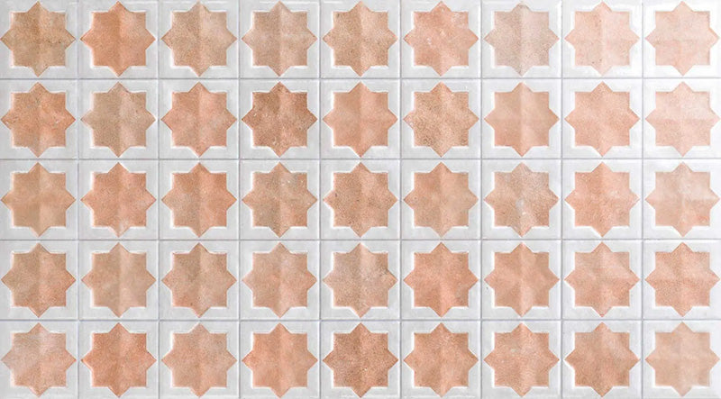 Close-up of Zeina Moroccan Cotto White ceramic wall tiles featuring a repeating Moroccan style geometric star pattern in warm terracotta and crisp white tones, with a glossy glazed finish, subtle shade variation and handcrafted-inspired character.