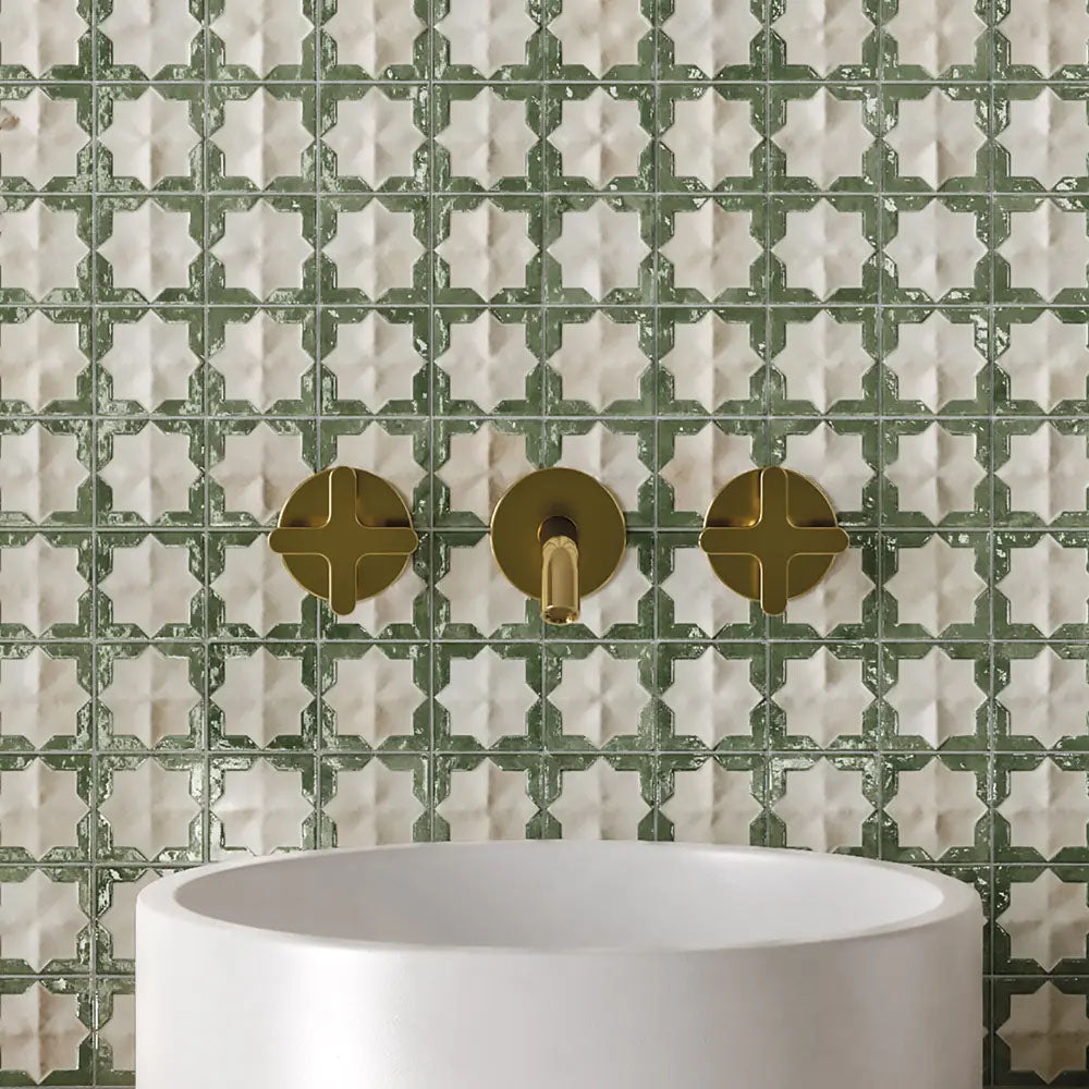 Bathroom vanity featuring Zeina Moroccan Emerald Green ceramic wall tiles in a repeating Moroccan style geometric pattern, paired with a round white basin, brushed brass wall-mounted taps and contemporary styling to create a timeless Mediterranean-inspired bathroom.