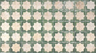 Close-up of Zeina Moroccan Emerald Green ceramic wall tiles featuring a Moroccan style geometric star pattern in soft white and rich emerald green with a glossy finish and subtle aged effect, suitable for kitchen splashbacks, bathroom walls and feature walls.