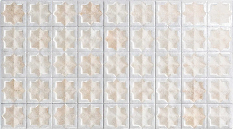 Close-up of Zeina Moroccan Natural White ceramic wall tiles featuring a repeating Moroccan style geometric star pattern in soft white and warm natural tones, with a glossy glazed finish, subtle shade variation and handcrafted-inspired detailing.