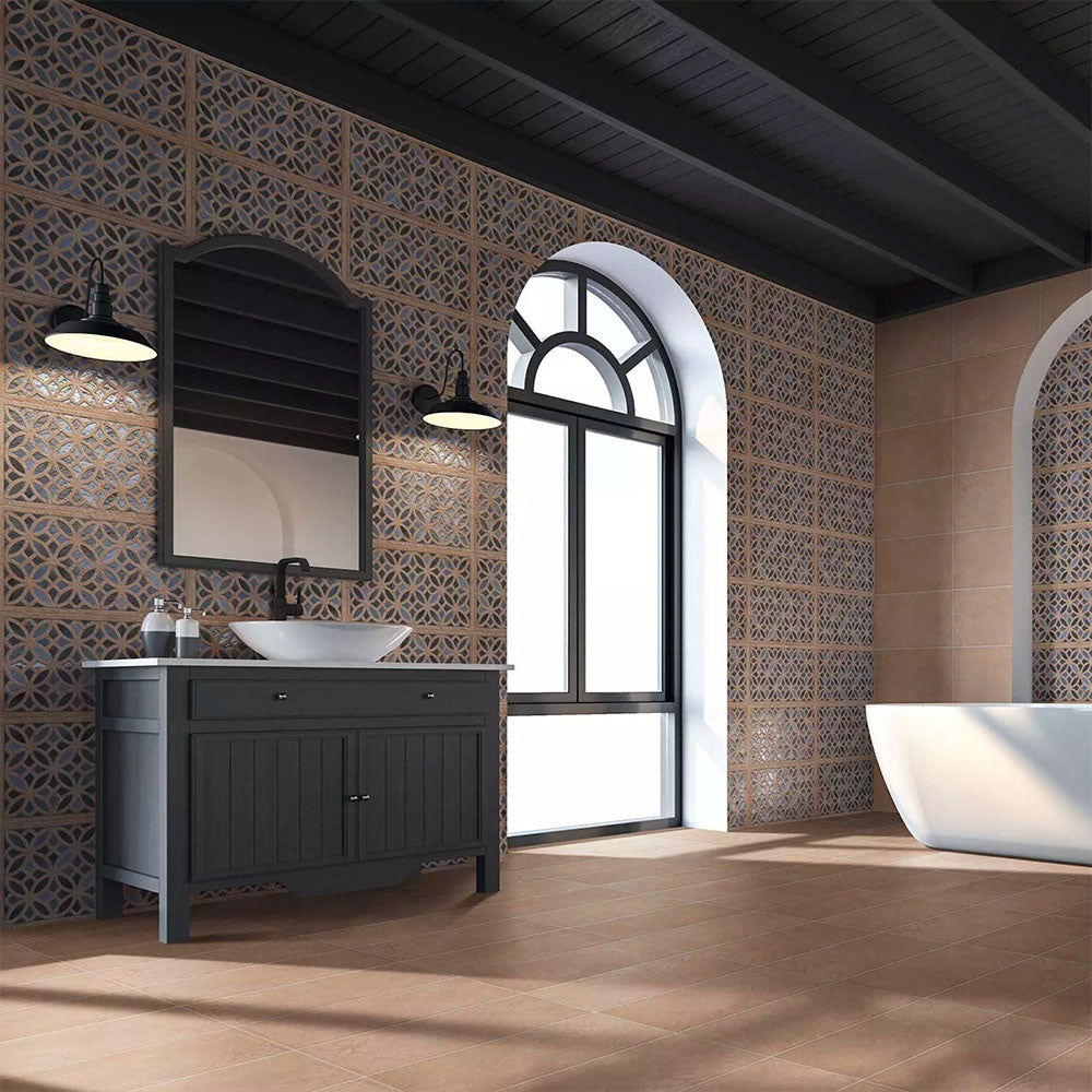 Bathroom featuring Ziza Azure Blue Moroccan style decorative porcelain wall tiles, showcasing an intricate geometric floral pattern in rich azure blue, charcoal, beige and cream tones with an aged finish, paired with warm terracotta floor tiles, black vanity furniture, arched windows and contemporary fixtures for a striking Moroccan-inspired interior.