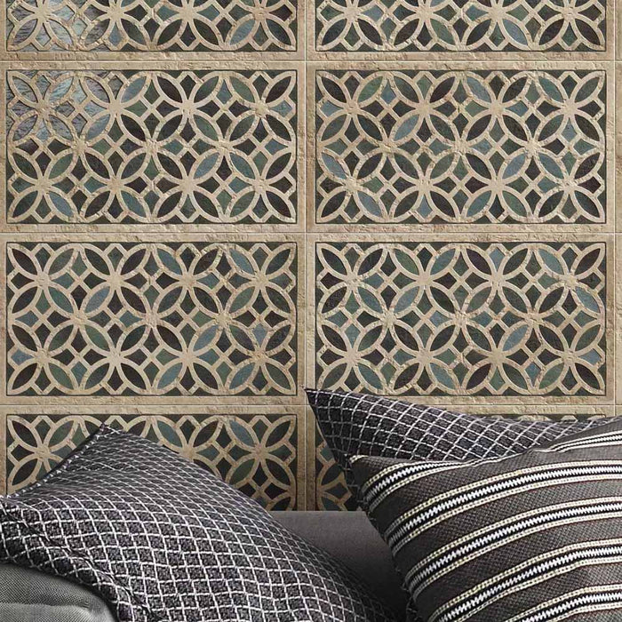 Close-up of Ziza Emerald Green Moroccan style decorative porcelain wall tiles, showcasing an intricate interlocking geometric pattern in rich emerald green, charcoal and warm stone tones with an aged finish, paired with textured charcoal cushions for a contemporary Moroccan-inspired living space.