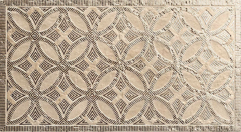 Close-up of Ziza Sandy Beach Moroccan style decorative porcelain wall tile, featuring an intricate carved geometric floral pattern in soft sandy beige and taupe tones with textured engraved detailing and a gently aged finish, perfect for creating statement bathroom walls, kitchen splashbacks and feature walls with timeless Moroccan-inspired character.