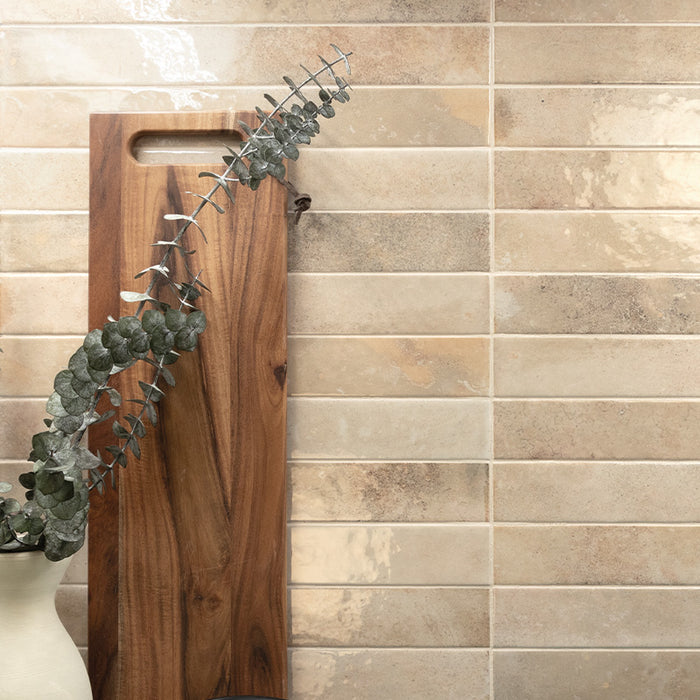 Almond gloss 5x40 wall tiles laid horizontally, featuring subtle tonal variation and a soft reflective finish.