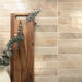 Almond gloss 5x40 wall tiles laid horizontally, featuring subtle tonal variation and a soft reflective finish.