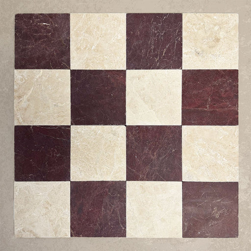 Flat lay of Fitzrovia Claret Red 15.2x15.2cm tumbled natural marble tiles paired with light marble in a classic chequerboard pattern, showcasing rich burgundy tones, soft neutral contrast, and natural veining.