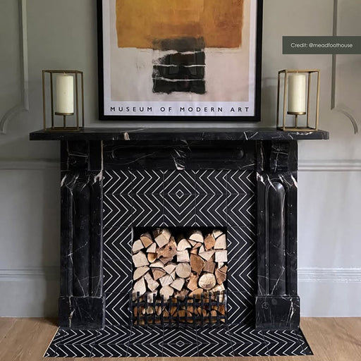 Living room fireplace featuring Alhambra Zig Zag Black 20cm x 20cm Moroccan style ceramic wall and floor tiles, showcasing a bold black and white geometric pattern styled within a classic mantel surround.