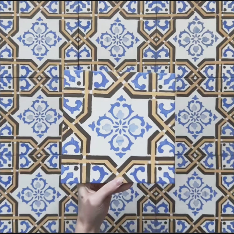Video showcasing the Carnaby Maestro Victorian Style porcelain tiles in a 20×20cm size, featuring a detailed blue and terracotta geometric floral pattern on a soft white background. The footage highlights the matt finish, intricate Victorian-inspired design, and how the repeating pattern looks across multiple tiles.