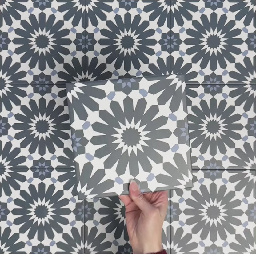 Video showcasing Fizaan Federal Blue 20x20cm Moroccan-style porcelain tiles, highlighting the repeating geometric pattern and deep blue and soft neutral tones in close-up detail.