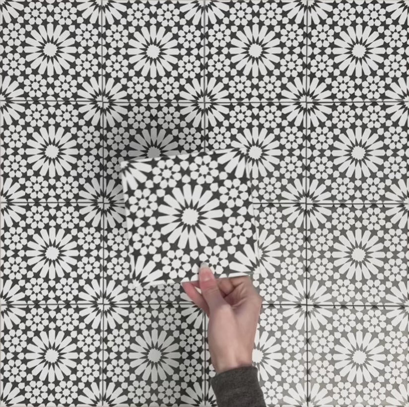 Video showcasing Fizaan Winter Mini Moroccan-style 15×15cm porcelain tiles, highlighting the bold black and white geometric star pattern and surface detail.