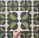 Video showcasing the Geometry Illusion Verde Noir 20x20cm geometric patterned tile, highlighting its green and black semicircle design with cream intersecting diamonds, and demonstrating how the pattern forms bold repeats when multiple tiles are laid together.