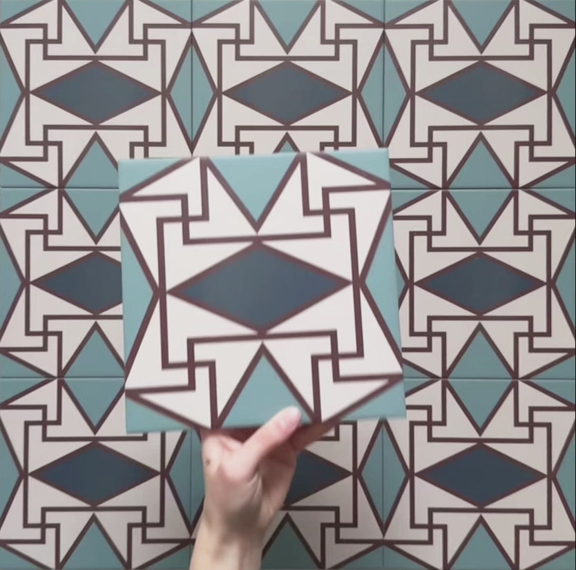 Video showcasing the Geometry Iris 20x20cm patterned tile, highlighting its intricate teal, navy, terracotta-red, and cream geometric design, and demonstrating how the pattern connects and repeats when multiple tiles are laid together.