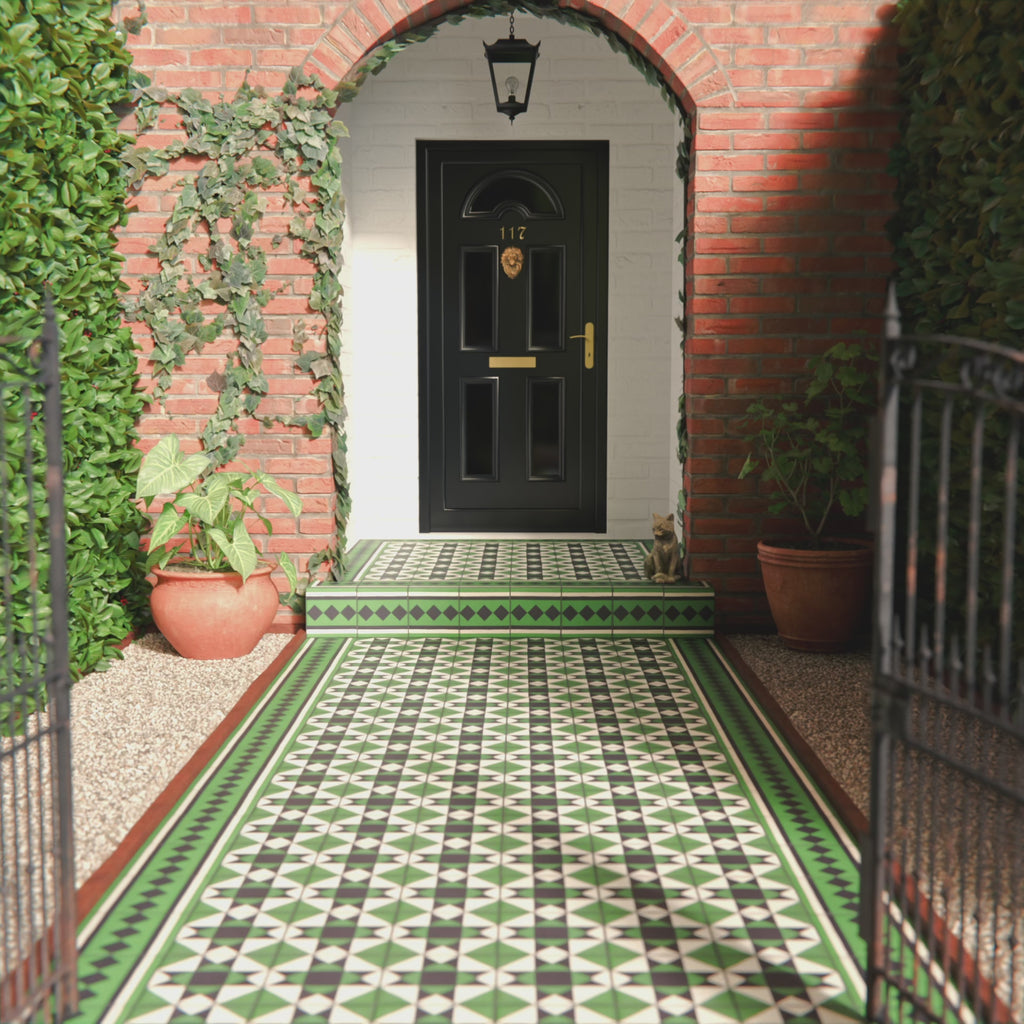 Maison Green Decor Victorian Pattern 20cm x 20cm walkway setting, Victorian-style patterned floor tiles laid in a geometric diamond design, rich green, black and white colour palette, matt finish with decorative border detailing, classic heritage-inspired design used in an outdoor entrance walkway.
