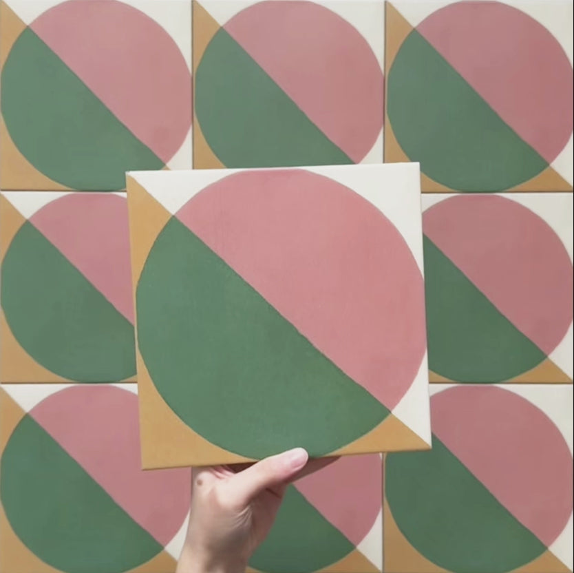 Video showcasing the Geometry Paloma 20x20cm geometric patterned tile, highlighting its pink and green semicircle design with mustard and cream corner details, and demonstrating how the pattern connects when multiple tiles are laid together.