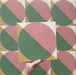 Video showcasing the Geometry Paloma 20x20cm geometric patterned tile, highlighting its pink and green semicircle design with mustard and cream corner details, and demonstrating how the pattern connects when multiple tiles are laid together.