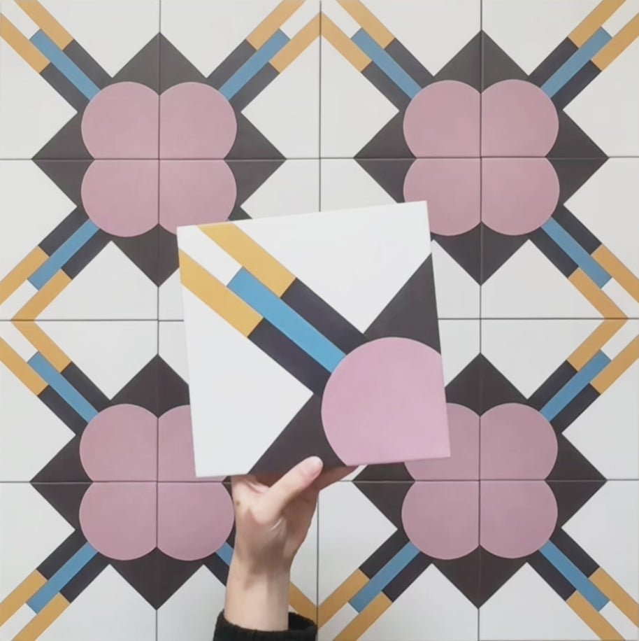 Video showcasing the Geometry Contour Patterned Tile in 20cm x 20cm, featuring a geometric design with soft pink circular shapes, intersecting mustard yellow and blue lines, and black diamond accents on a white background. The video highlights the tile’s colours, pattern details, and overall modern, graphic style.