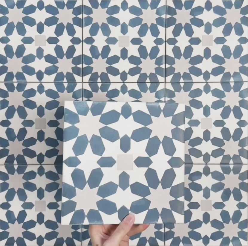 Video showcasing Soukaina Blue C Moroccan-style 20cm x 20cm patterned porcelain tiles, highlighting the repeating geometric star design, rich blue and neutral colour palette, and matt finish when laid together.